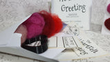 close up of needle felting kit wool fibres pink, red, wine and needle felting template