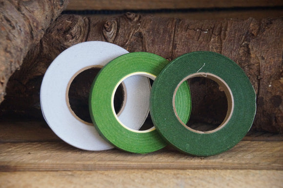 florist tape in 3 colours on a log background