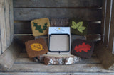 set of 4 woodland leaf themed coasters surrounding the coaster template in a rustic wooden background